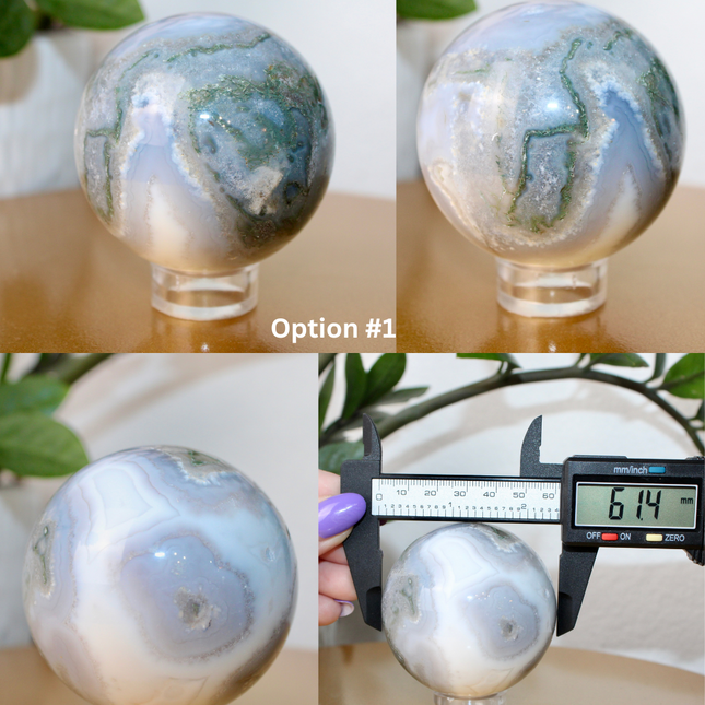 This XL Moss Agate Sphere features a stunning mix of natural green inclusions and cloudy white tones, reminiscent of forest landscapes or underwater gardens. Each sphere is one of a kind, with swirling patterns and depth that make it a true conversation piece.