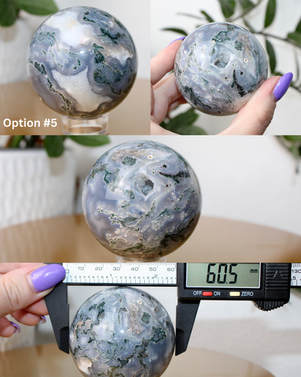 This XL Moss Agate Sphere features a stunning mix of natural green inclusions and cloudy white tones, reminiscent of forest landscapes or underwater gardens. Each sphere is one of a kind, with swirling patterns and depth that make it a true conversation piece.