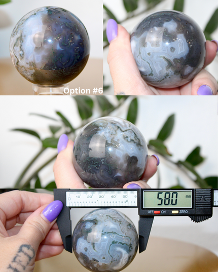 This XL Moss Agate Sphere features a stunning mix of natural green inclusions and cloudy white tones, reminiscent of forest landscapes or underwater gardens. Each sphere is one of a kind, with swirling patterns and depth that make it a true conversation piece.