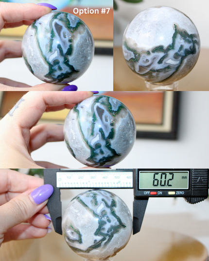 This XL Moss Agate Sphere features a stunning mix of natural green inclusions and cloudy white tones, reminiscent of forest landscapes or underwater gardens. Each sphere is one of a kind, with swirling patterns and depth that make it a true conversation piece.