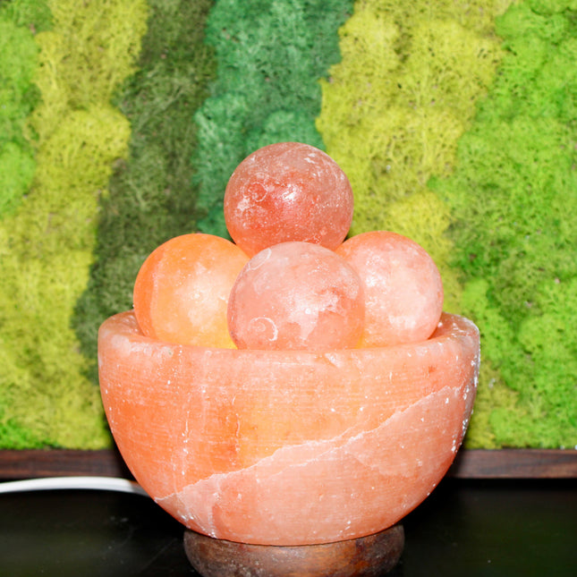 An extra-large Himalayan Salt Lamp featuring a handcrafted, bowl-shaped salt crystal base filled with smooth, removable Himalayan salt massage balls. The lamp emits a warm, amber glow that creates a calming ambiance, perfect for relaxation, meditation, or bedroom lighting. Each massage ball is made from the same high-quality pink salt and can be used warm for soothing sore muscles or kept in the bowl for a decorative touch.