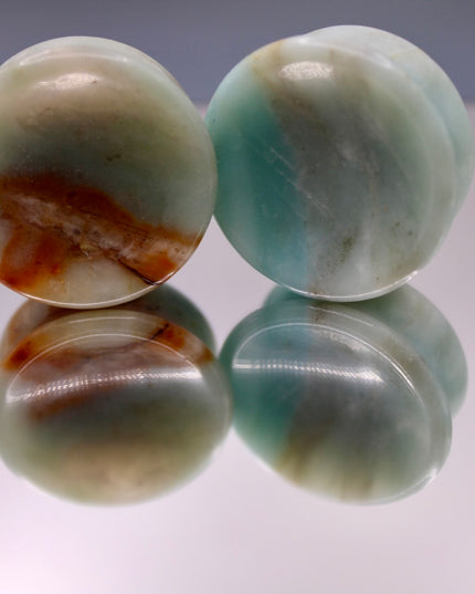 A beautiful pair of Natural Calcite stone plugs, hand-carved and polished into a smooth double flare shape for a secure and comfortable fit. These ear gauges showcase the soft, luminous quality of calcite, with creamy whites, warm honey tones, and subtle translucency that varies from piece to piece. Each plug highlights unique natural banding and organic patterns, making every pair one-of-a-kind.