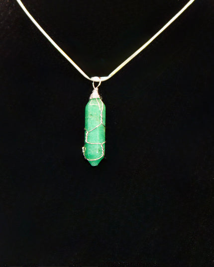 Green pendant necklace on a black stand with a white background