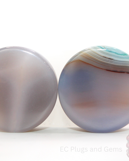 Two agate ear gauges plugs with a visible ec plugs logo on a white background