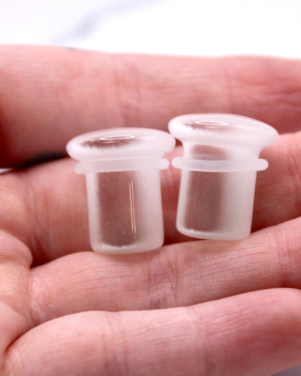 Polished white cat eye glass plugs with subtle chatoyancy and secure single flare design – perfect for everyday wear.