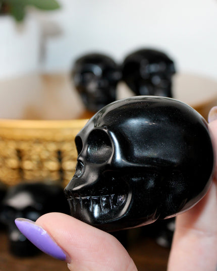 This Black Obsidian Skull Carving blends bold visual impact with detailed craftsmanship. Perfect for display in any setting, each polished obsidian skull showcases the rich depth and shine of natural volcanic glass.