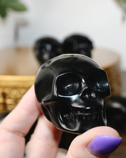 This Black Obsidian Skull Carving blends bold visual impact with detailed craftsmanship. Perfect for display in any setting, each polished obsidian skull showcases the rich depth and shine of natural volcanic glass.