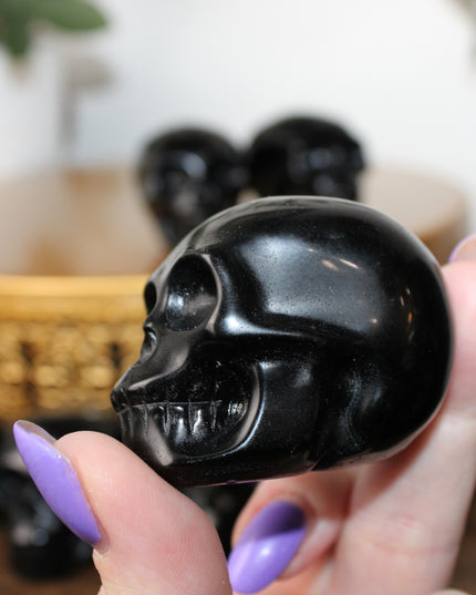 This Black Obsidian Skull Carving blends bold visual impact with detailed craftsmanship. Perfect for display in any setting, each polished obsidian skull showcases the rich depth and shine of natural volcanic glass.