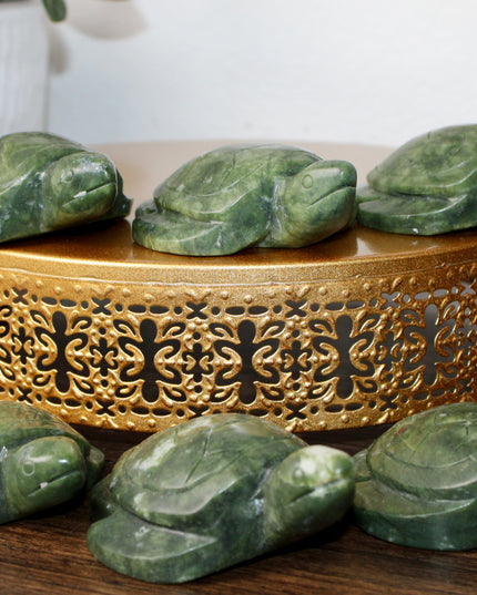 This Xiuyan Jade Turtle Carving is a beautifully detailed figurine made from genuine jade stone. Hand-carved and polished, it features gentle green tones and natural variations that make each piece one of a kind. Whether used as a decorative accent or gifted to a collector, this turtle brings a timeless and earthy charm to any space.