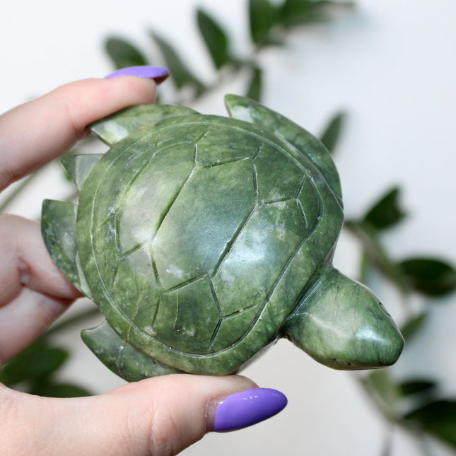 This Xiuyan Jade Turtle Carving is a beautifully detailed figurine made from genuine jade stone. Hand-carved and polished, it features gentle green tones and natural variations that make each piece one of a kind. Whether used as a decorative accent or gifted to a collector, this turtle brings a timeless and earthy charm to any space.