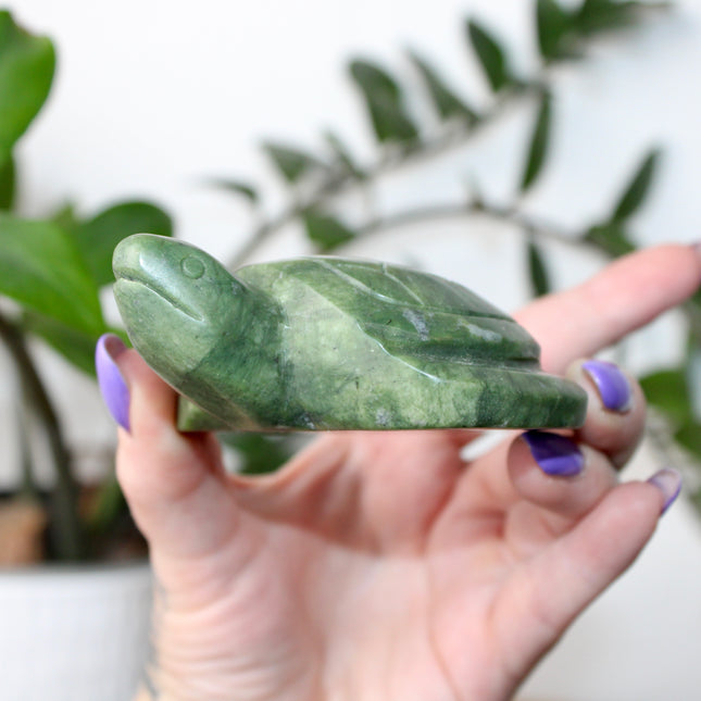 This Xiuyan Jade Turtle Carving is a beautifully detailed figurine made from genuine jade stone. Hand-carved and polished, it features gentle green tones and natural variations that make each piece one of a kind. Whether used as a decorative accent or gifted to a collector, this turtle brings a timeless and earthy charm to any space.