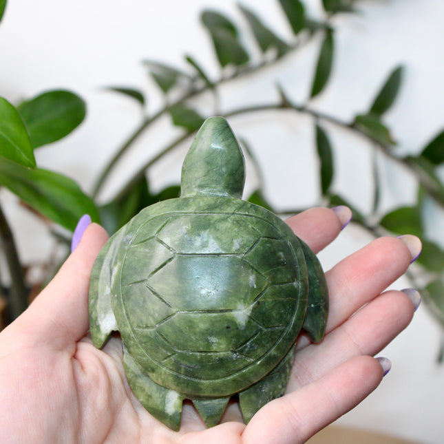 This Xiuyan Jade Turtle Carving is a beautifully detailed figurine made from genuine jade stone. Hand-carved and polished, it features gentle green tones and natural variations that make each piece one of a kind. Whether used as a decorative accent or gifted to a collector, this turtle brings a timeless and earthy charm to any space.