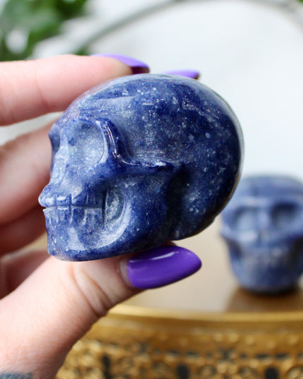 This 2.5" Blue Aventurine Skull is expertly hand-carved from natural gemstone, showcasing rich blue tones and intricate detailing. Each piece is polished to a smooth finish, making it a striking addition to any space. Due to the natural material, each skull is one of a kind, with unique patterns and shading.