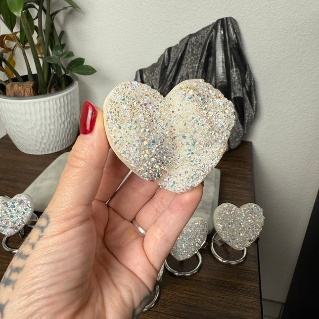 These Electroplated Aura Quartz Hearts combine the universal symbol of love with brilliant color and energy—set beautifully on a metal stand for easy display. Whether you're building your altar, brightening a room, or gifting crystal magic, pick the piece that sparks your spirit.