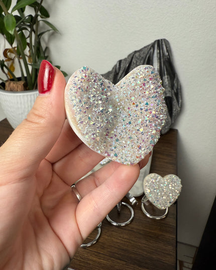 These Electroplated Aura Quartz Hearts combine the universal symbol of love with brilliant color and energy—set beautifully on a metal stand for easy display. Whether you're building your altar, brightening a room, or gifting crystal magic, pick the piece that sparks your spirit.