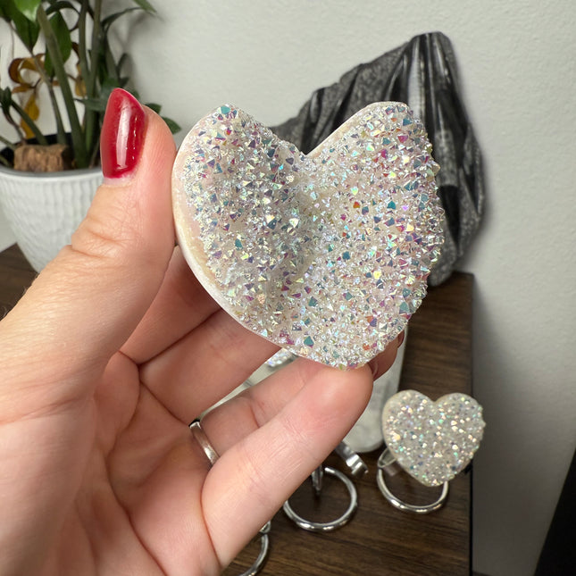 These Electroplated Aura Quartz Hearts combine the universal symbol of love with brilliant color and energy—set beautifully on a metal stand for easy display. Whether you're building your altar, brightening a room, or gifting crystal magic, pick the piece that sparks your spirit.