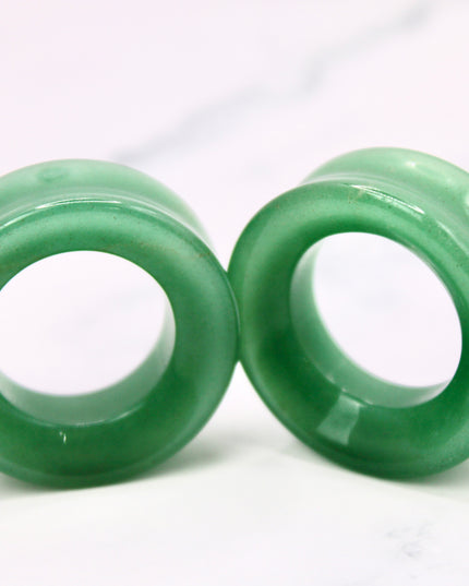 Two green jade aventurine rings on a white background