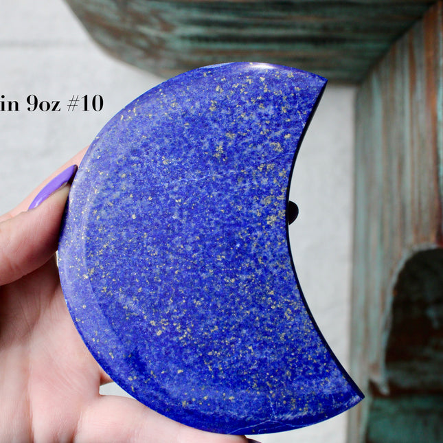 Crescent-shaped blue lapis held by a hand with text indicating size and option.