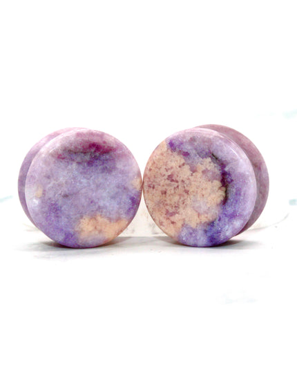 Round purple jasper plugs on a white background