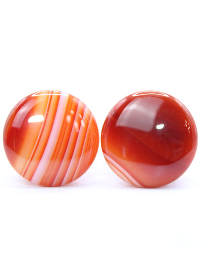 These single flare plugs are carved from genuine Carnelian Agate, showcasing warm, fiery hues and occasional natural banding or translucent zones. Hand-polished to a sleek finish, each plug is smooth and comfortable for everyday wear.