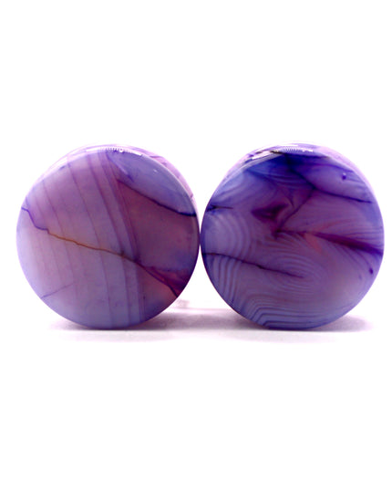 These Purple Striped Agate Plugs showcase eye-catching banded patterns and vivid color in a comfortable double flare design. Polished to a glossy finish, they’re a stylish choice for stretched ear jewelry collections.