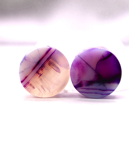 These Purple Striped Agate Plugs showcase eye-catching banded patterns and vivid color in a comfortable double flare design. Polished to a glossy finish, they’re a stylish choice for stretched ear jewelry collections.