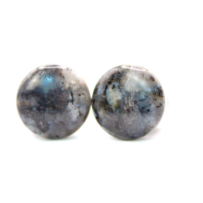 These single flare plugs are crafted from genuine Larvikite, often called Black Labradorite, and feature a dark, elegant appearance with natural silver or blue reflective flash. Each plug is polished to a smooth finish for comfort and style.