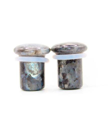 These single flare plugs are crafted from genuine Larvikite, often called Black Labradorite, and feature a dark, elegant appearance with natural silver or blue reflective flash. Each plug is polished to a smooth finish for comfort and style.