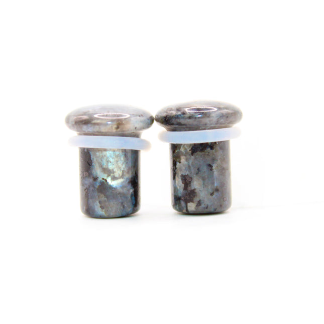 These single flare plugs are crafted from genuine Larvikite, often called Black Labradorite, and feature a dark, elegant appearance with natural silver or blue reflective flash. Each plug is polished to a smooth finish for comfort and style.