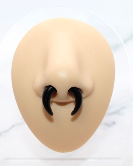 This Obsidian Septum Pincher is carved from genuine volcanic glass and polished to a smooth, glossy finish.