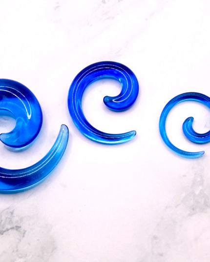 These Blue Acrylic Spiral Tapers offer a bold, colorful twist to your stretched ear collection. With their vibrant blue tone and swirling design, they’re perfect for adding movement and personality to your look. Made from lightweight acrylic, they’re easy to wear and ideal for daily use or special occasions.