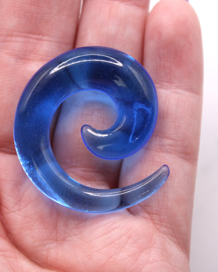 These Blue Acrylic Spiral Tapers offer a bold, colorful twist to your stretched ear collection. With their vibrant blue tone and swirling design, they’re perfect for adding movement and personality to your look. Made from lightweight acrylic, they’re easy to wear and ideal for daily use or special occasions.
