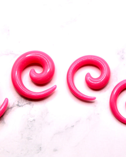 These Pink Acrylic Spiral Taper Earrings are a stylish and low-maintenance option for stretched ears. The sleek spiral design adds visual interest while remaining lightweight and easy to wear. Perfect for everyday use or to enhance your alt aesthetic, these tapers offer a bold yet classic look.