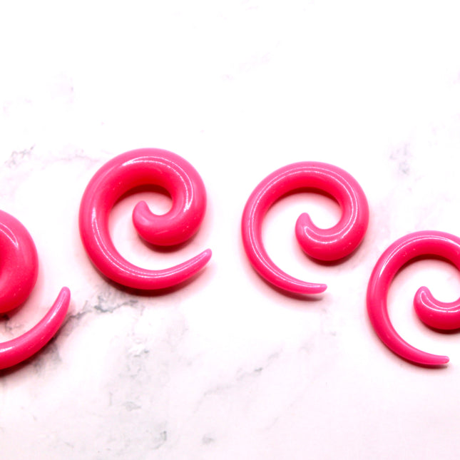 These Pink Acrylic Spiral Taper Earrings are a stylish and low-maintenance option for stretched ears. The sleek spiral design adds visual interest while remaining lightweight and easy to wear. Perfect for everyday use or to enhance your alt aesthetic, these tapers offer a bold yet classic look.