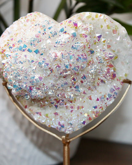 These Electroplated Aura Quartz Hearts combine the universal symbol of love with brilliant color and energy—set beautifully on a metal stand for easy display. Whether you're building your altar, brightening a room, or gifting crystal magic, pick the piece that sparks your spirit.