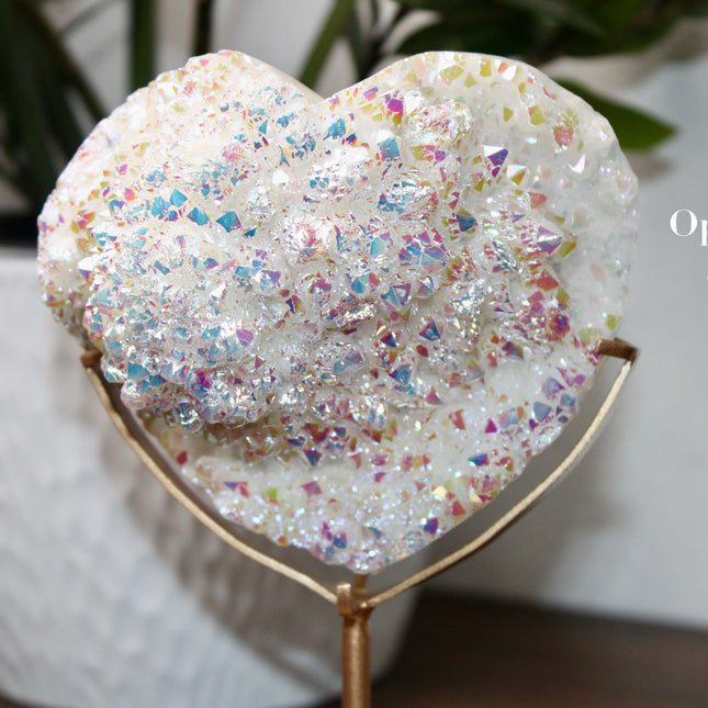 These Electroplated Aura Quartz Hearts combine the universal symbol of love with brilliant color and energy—set beautifully on a metal stand for easy display. Whether you're building your altar, brightening a room, or gifting crystal magic, pick the piece that sparks your spirit.
