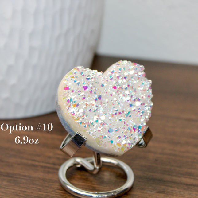 These Electroplated Aura Quartz Hearts combine the universal symbol of love with brilliant color and energy—set beautifully on a metal stand for easy display. Whether you're building your altar, brightening a room, or gifting crystal magic, pick the piece that sparks your spirit.