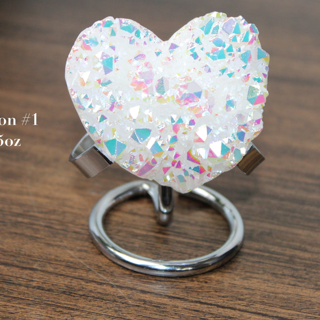 These Electroplated Aura Quartz Hearts combine the universal symbol of love with brilliant color and energy—set beautifully on a metal stand for easy display. Whether you're building your altar, brightening a room, or gifting crystal magic, pick the piece that sparks your spirit.