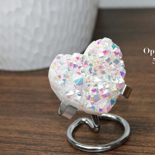 These Electroplated Aura Quartz Hearts combine the universal symbol of love with brilliant color and energy—set beautifully on a metal stand for easy display. Whether you're building your altar, brightening a room, or gifting crystal magic, pick the piece that sparks your spirit.