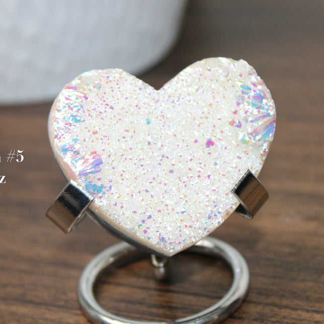 These Electroplated Aura Quartz Hearts combine the universal symbol of love with brilliant color and energy—set beautifully on a metal stand for easy display. Whether you're building your altar, brightening a room, or gifting crystal magic, pick the piece that sparks your spirit.