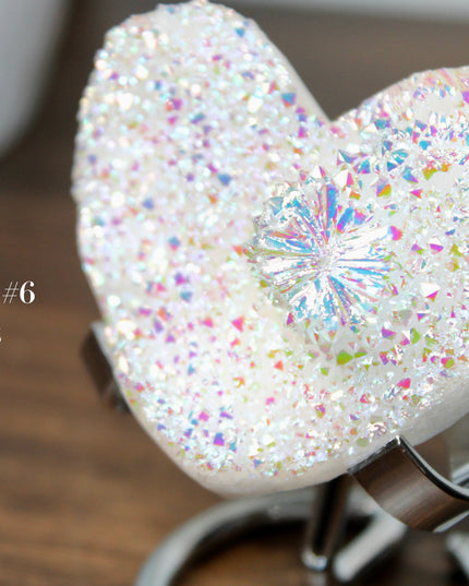 These Electroplated Aura Quartz Hearts combine the universal symbol of love with brilliant color and energy—set beautifully on a metal stand for easy display. Whether you're building your altar, brightening a room, or gifting crystal magic, pick the piece that sparks your spirit.