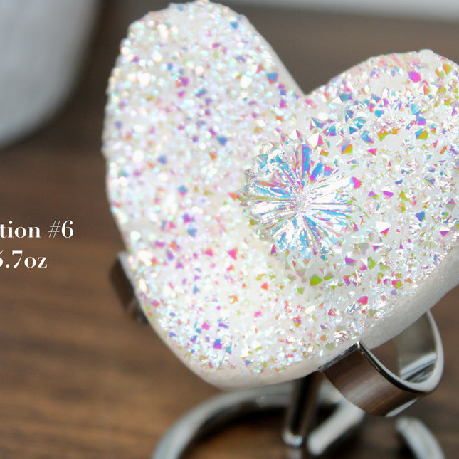 These Electroplated Aura Quartz Hearts combine the universal symbol of love with brilliant color and energy—set beautifully on a metal stand for easy display. Whether you're building your altar, brightening a room, or gifting crystal magic, pick the piece that sparks your spirit.