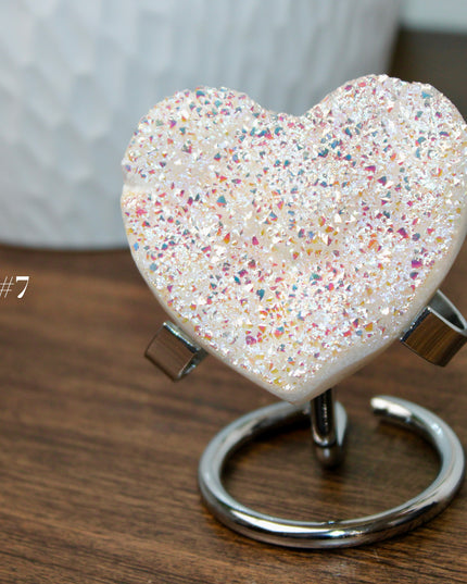 These Electroplated Aura Quartz Hearts combine the universal symbol of love with brilliant color and energy—set beautifully on a metal stand for easy display. Whether you're building your altar, brightening a room, or gifting crystal magic, pick the piece that sparks your spirit.