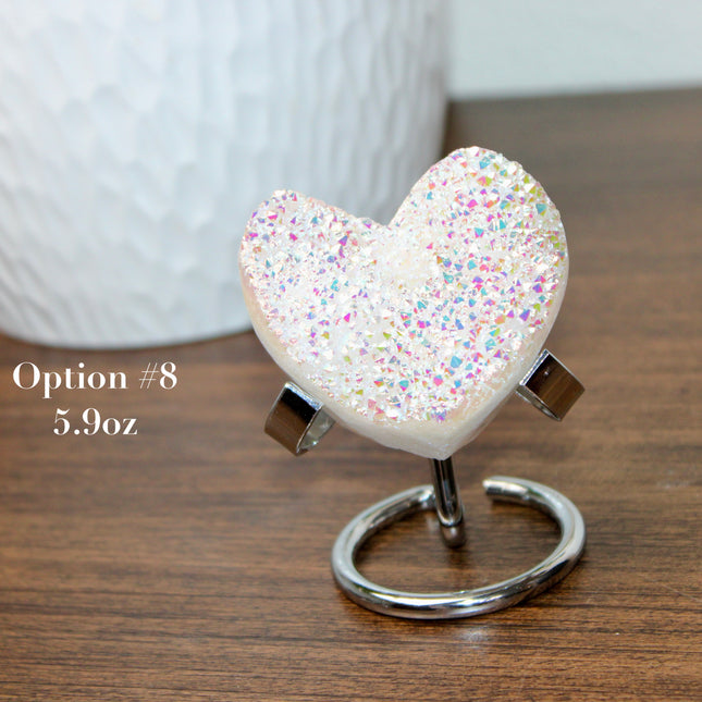 These Electroplated Aura Quartz Hearts combine the universal symbol of love with brilliant color and energy—set beautifully on a metal stand for easy display. Whether you're building your altar, brightening a room, or gifting crystal magic, pick the piece that sparks your spirit.