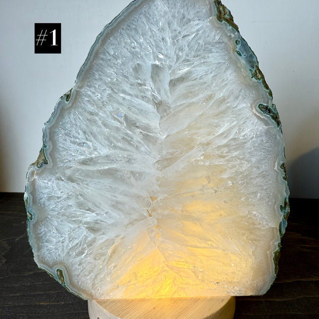 Crystal rock lamp with a warm glow on a dark surface