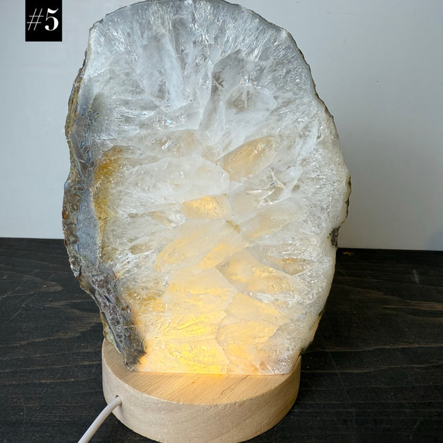 Lamp made from a crystal rock on a wooden base with a white background