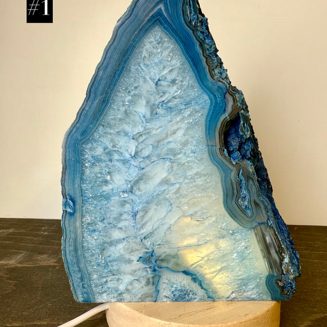 Geode-shaped lamp with blue interior on a wooden base