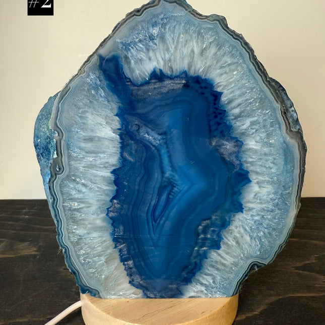 Geode-shaped lamp with blue interior on a wooden base