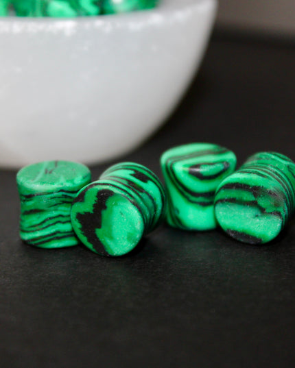 These Green and Black Synthetic Malachite Double Flare Plugs are perfect for anyone seeking a bold, polished look with nature-inspired vibes—great for everyday wear or completing your crystal-themed plug collection.