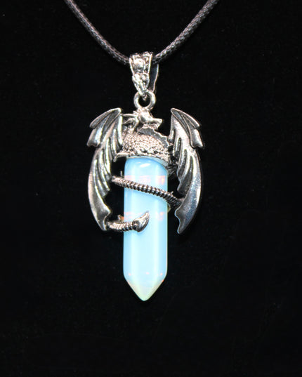 A fierce and enchanting Dragon Necklace with Opalite brings fantasy to life, featuring a detailed dragon wrapped protectively around a glowing opalite orb. The iridescent stone shimmers with soft hues of blue, lavender, and pearly white, catching light with a mystical glow. The dragon pendant is crafted with intricate scales and wings, giving it a bold, medieval-inspired aesthetic.